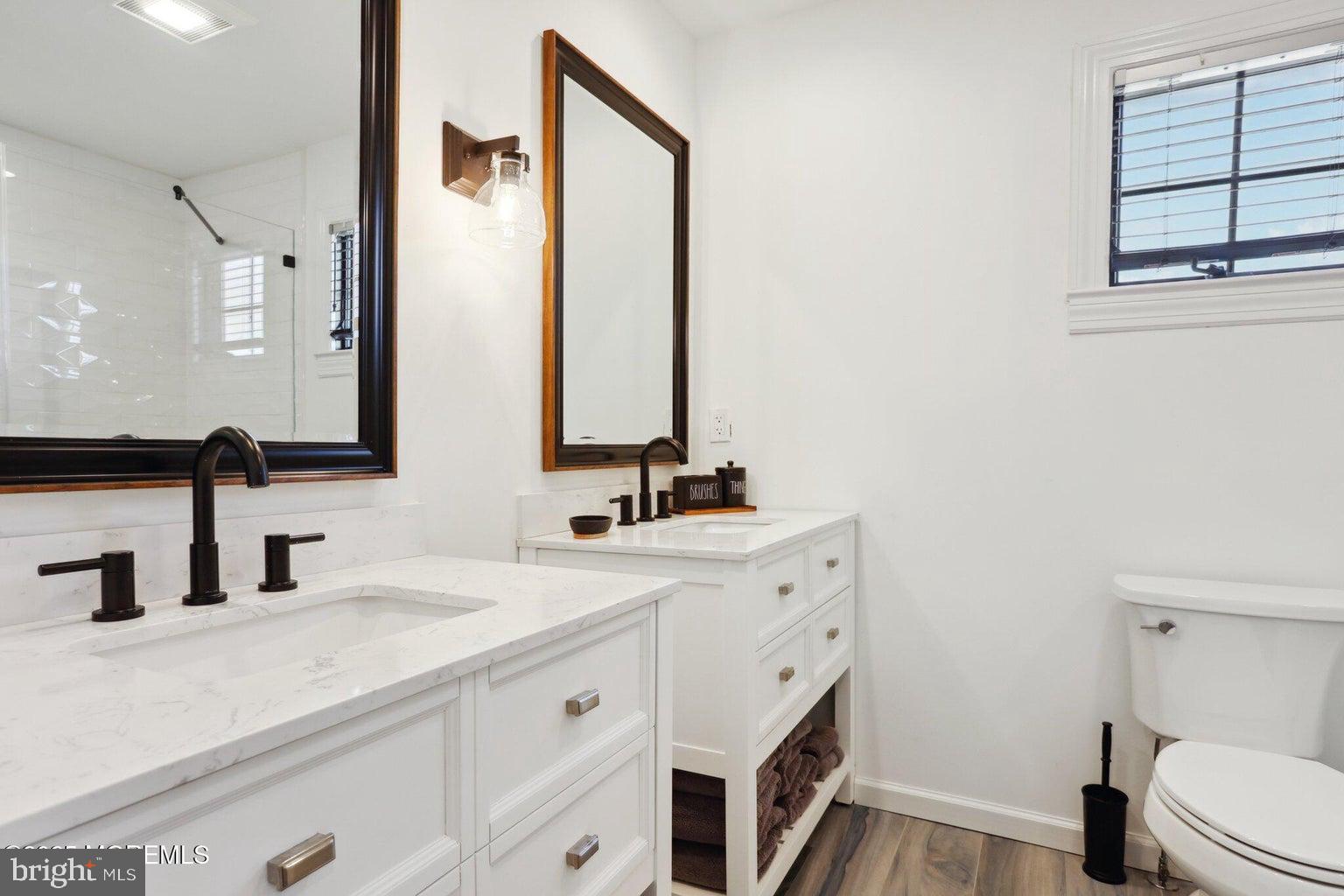 211 4th Street Beach Haven, NJ 08008 - Photo 25 of 48 a bathroom with a sink a toilet and mirror