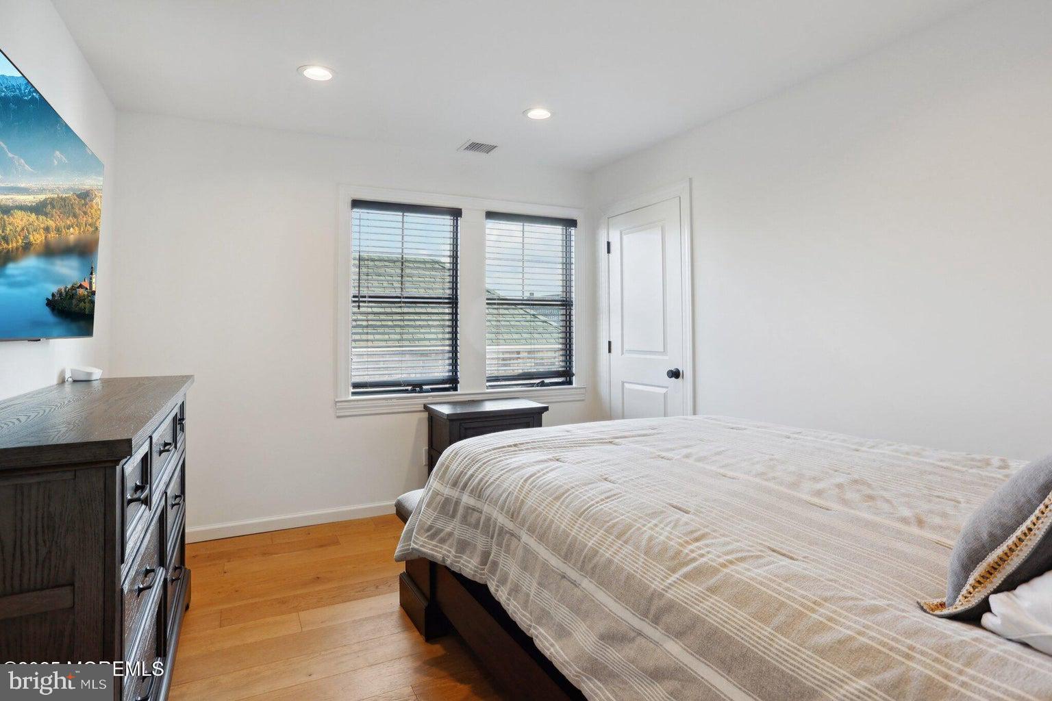 211 4th Street Beach Haven, NJ 08008 - Photo 28 of 48 a spacious bedroom with a bed and a window