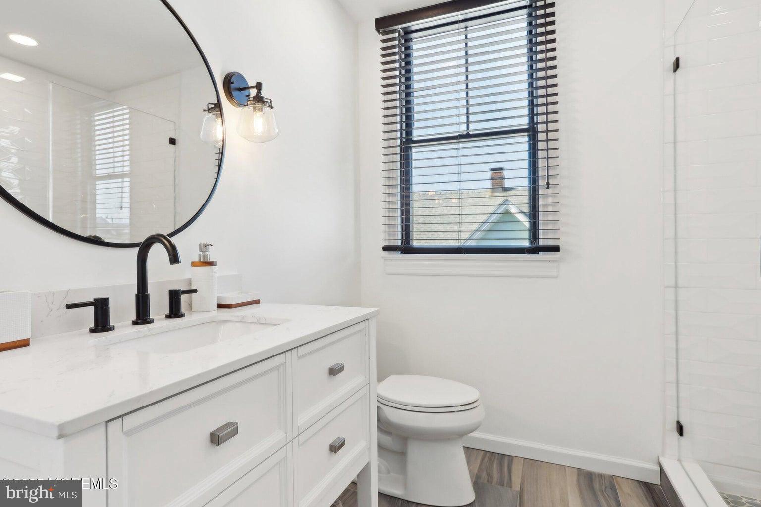 211 4th Street Beach Haven, NJ 08008 - Photo 29 of 48 a bathroom with a toilet sink and mirror