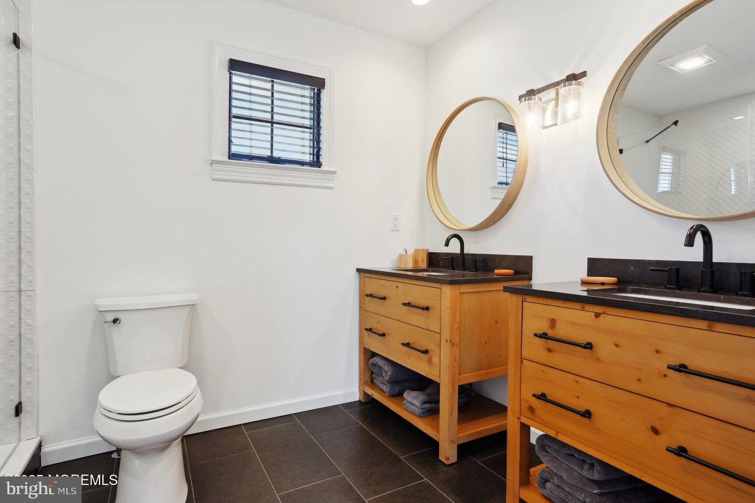 211 4th Street Beach Haven, NJ 08008 - Photo 37 of 48 a bathroom with a double vanity sink and a mirror