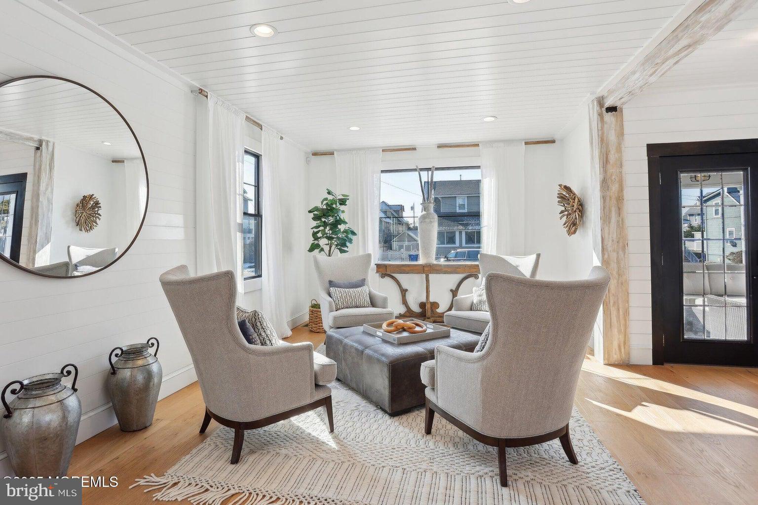 211 4th Street Beach Haven, NJ 08008 - Photo 8 of 48 a living room with furniture a large window and a potted plant