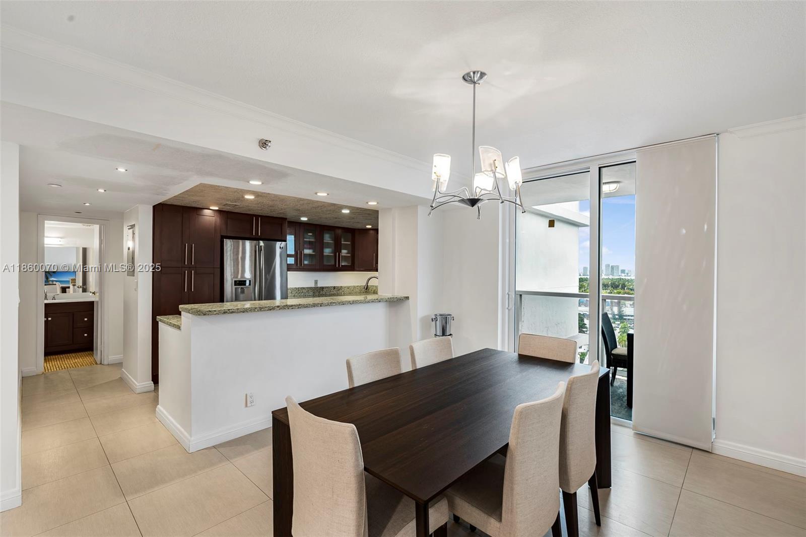 2401 Collins Avenue, Unit 1808 Miami Beach, FL 33140 - Photo 12 of 62 a view of a dining room and livingroom with furniture wooden floor a chandelier