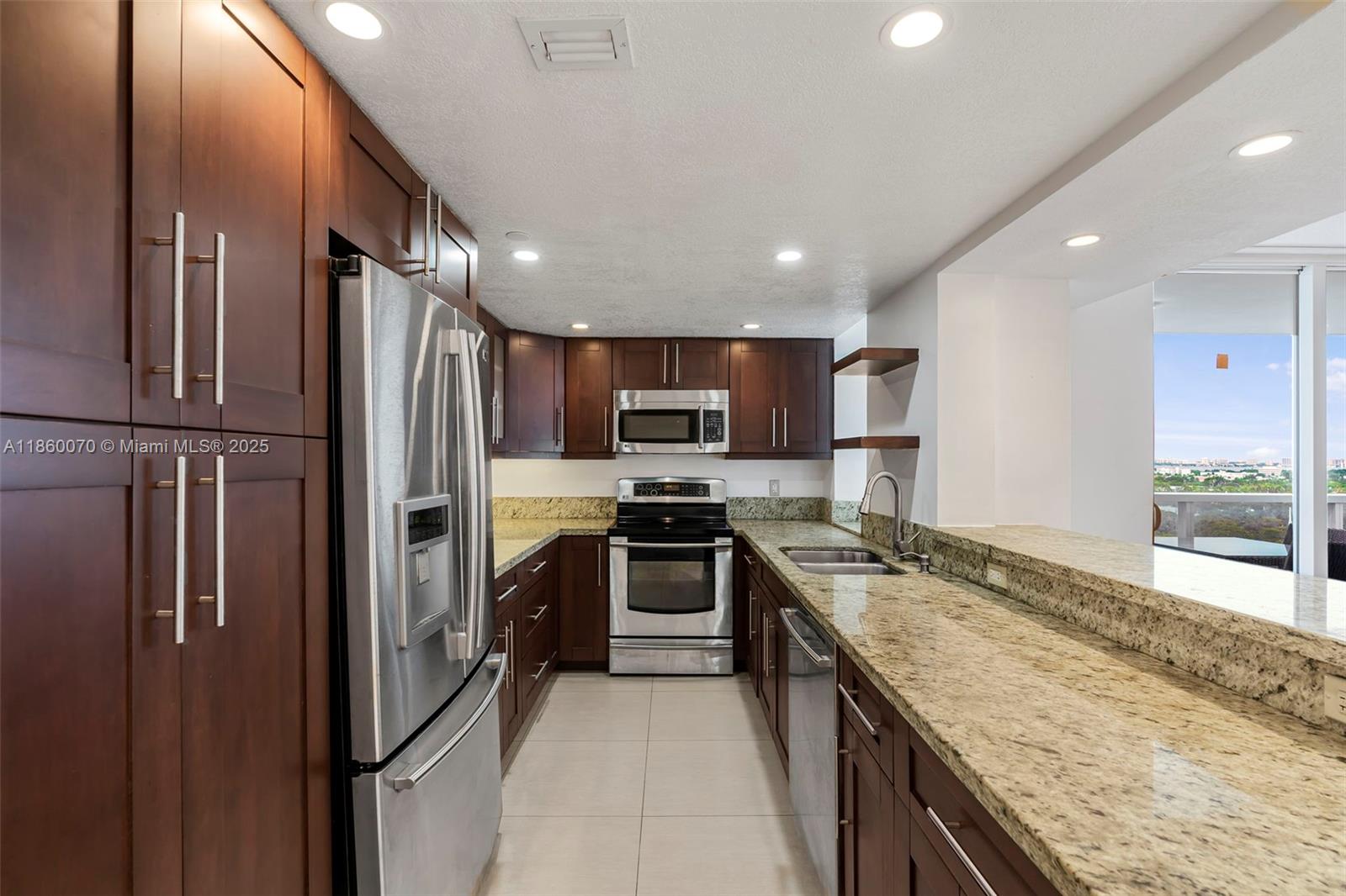 2401 Collins Avenue, Unit 1808 Miami Beach, FL 33140 - Photo 14 of 62 a kitchen with stainless steel appliances granite countertop a refrigerator stove and oven