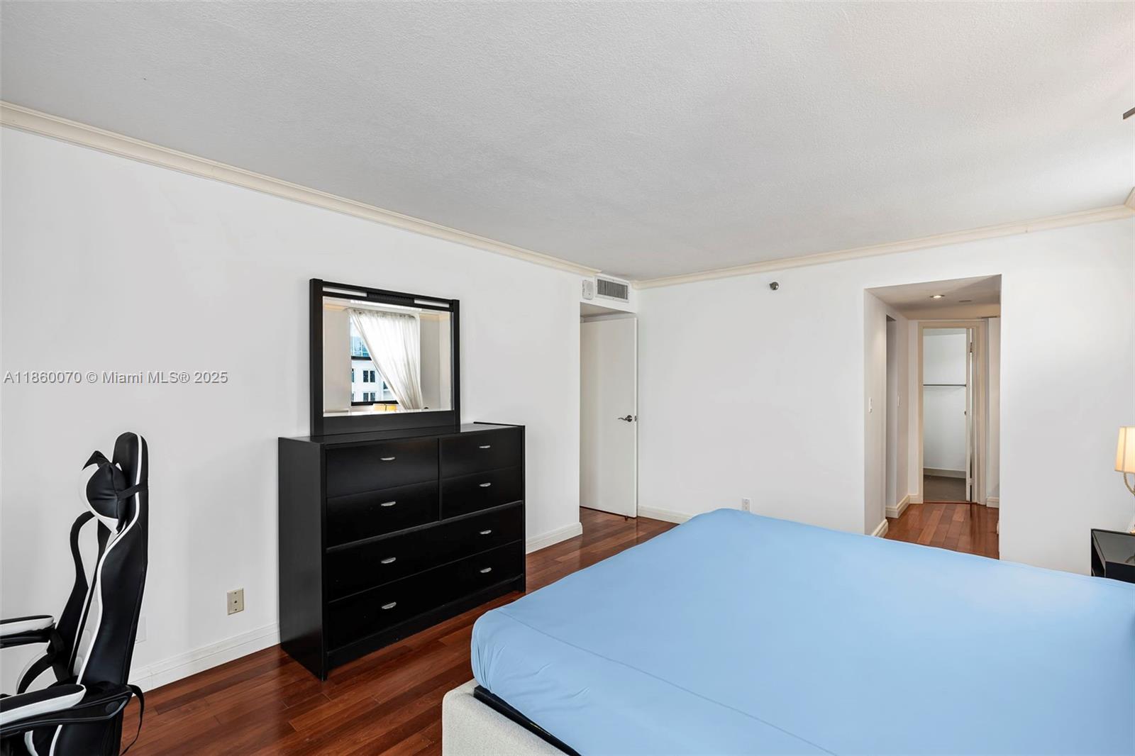 2401 Collins Avenue, Unit 1808 Miami Beach, FL 33140 - Photo 21 of 62 a bedroom with a bed and a mirror on dresser