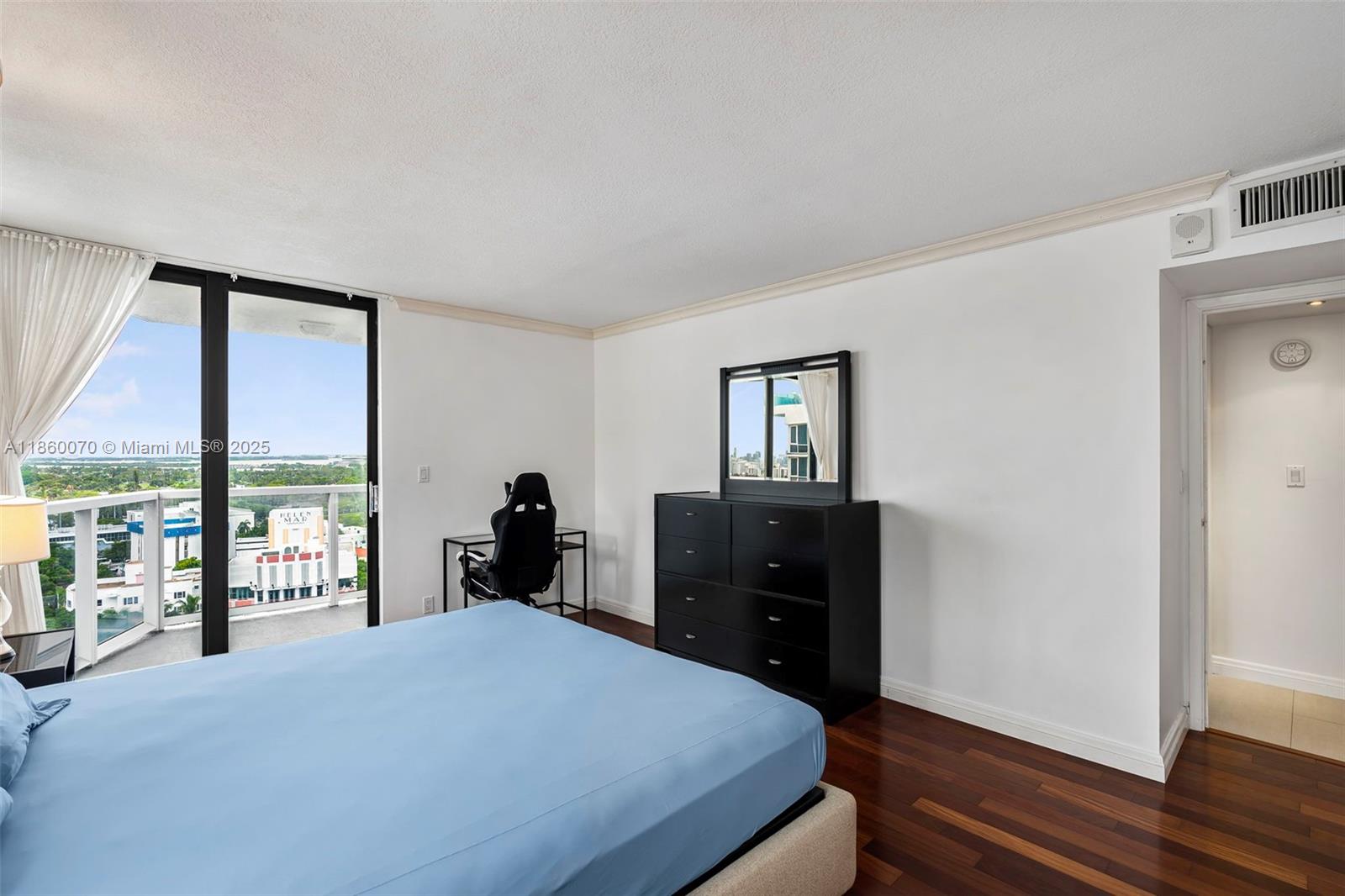 2401 Collins Avenue, Unit 1808 Miami Beach, FL 33140 - Photo 22 of 62 a bedroom with a bed and large windows