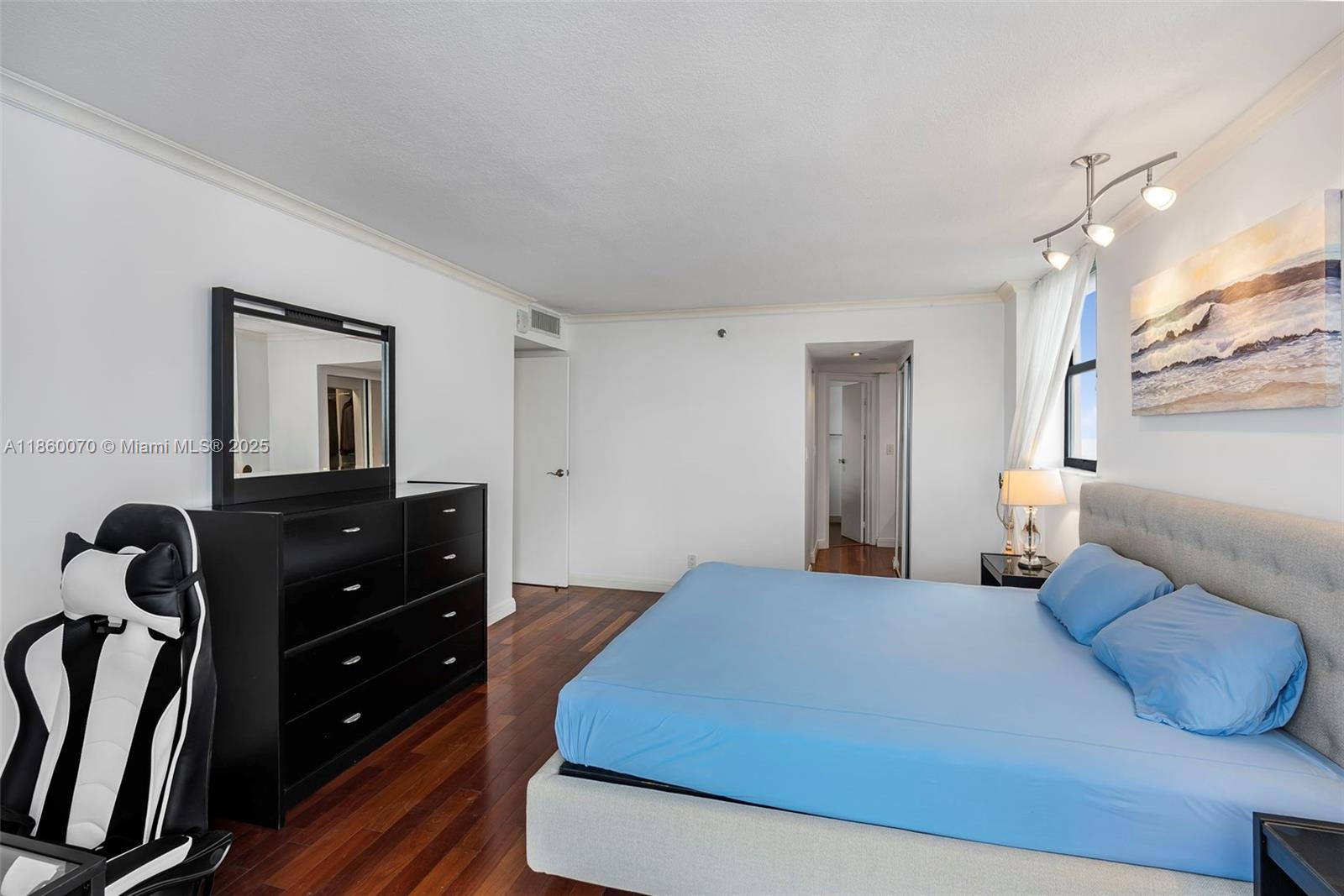 2401 Collins Avenue, Unit 1808 Miami Beach, FL 33140 - Photo 23 of 62 a bedroom with a bed and a dresser