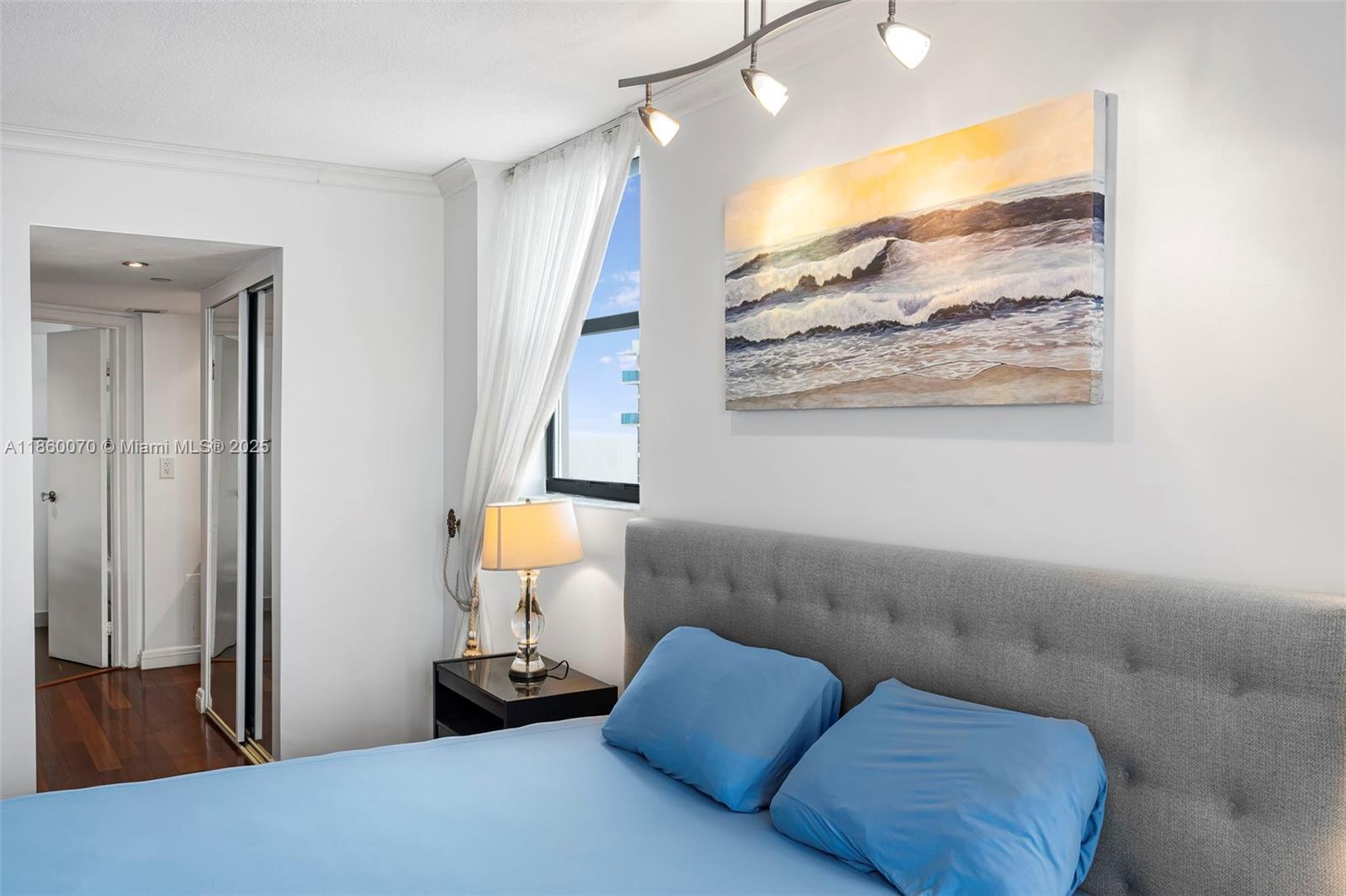 2401 Collins Avenue, Unit 1808 Miami Beach, FL 33140 - Photo 24 of 62 a bedroom with a bed and a painting on the wall