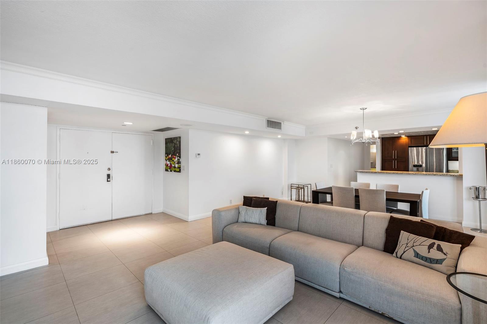 2401 Collins Avenue, Unit 1808 Miami Beach, FL 33140 - Photo 3 of 62 a living room with furniture and a lamp