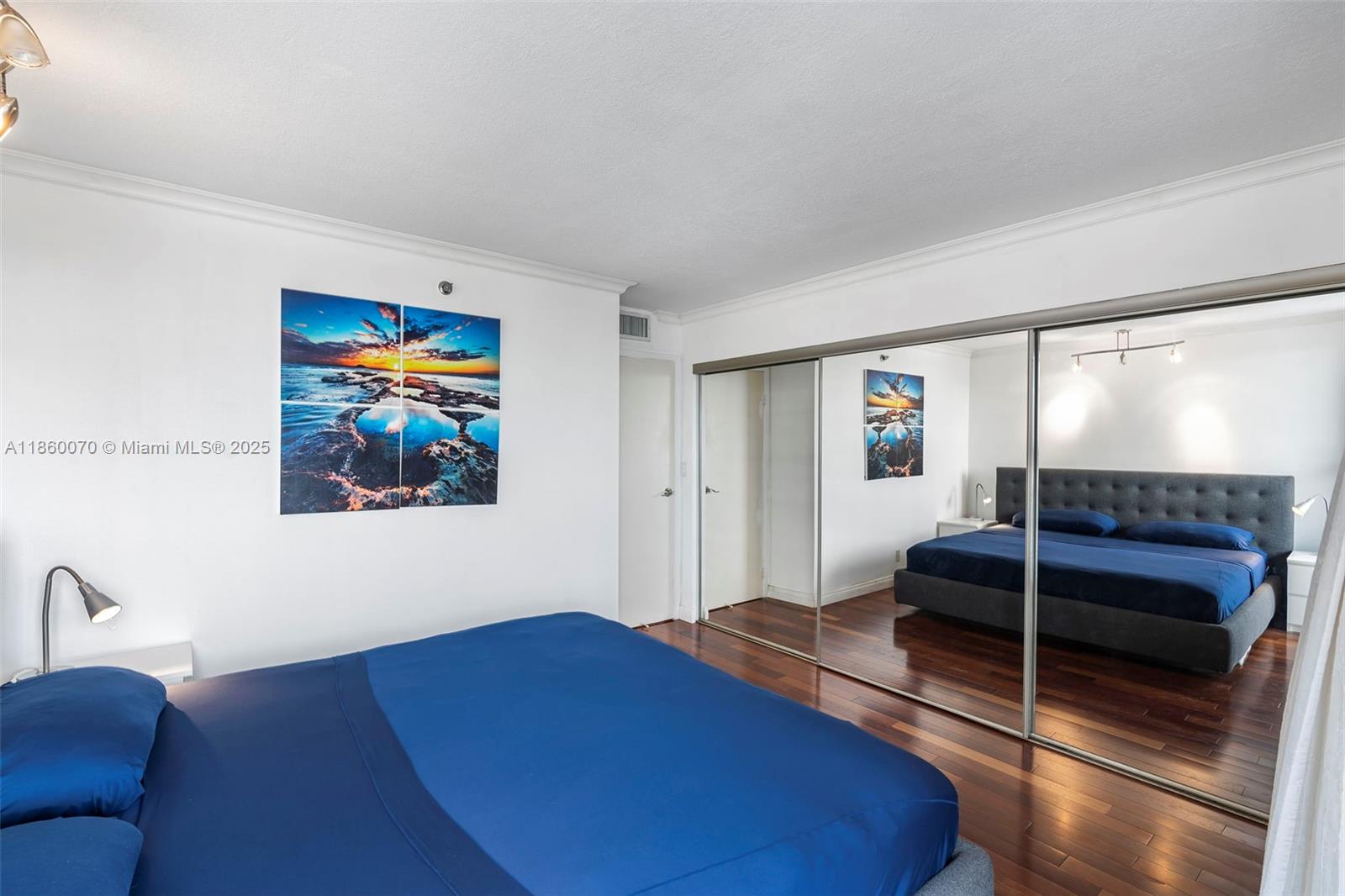 2401 Collins Avenue, Unit 1808 Miami Beach, FL 33140 - Photo 32 of 62 a bedroom with furniture and a mirror