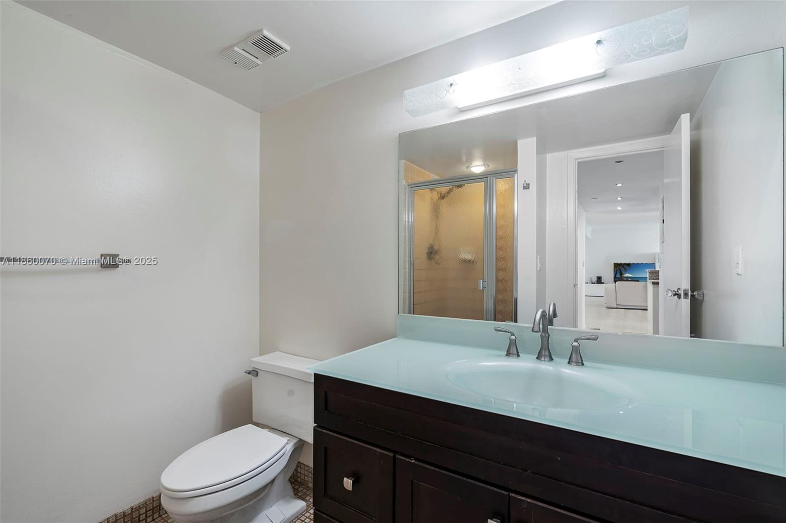 2401 Collins Avenue, Unit 1808 Miami Beach, FL 33140 - Photo 34 of 62 a bathroom with a sink a toilet a mirror and shower