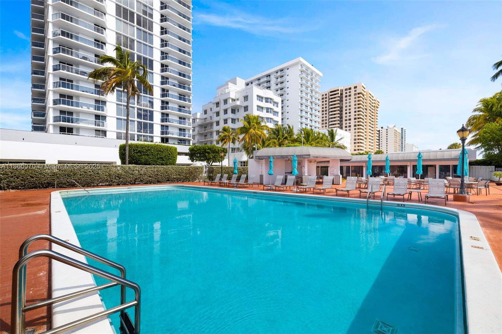 2401 Collins Avenue, Unit 1808 Miami Beach, FL 33140 - Photo 44 of 62 a view of a swimming pool with outdoor seating