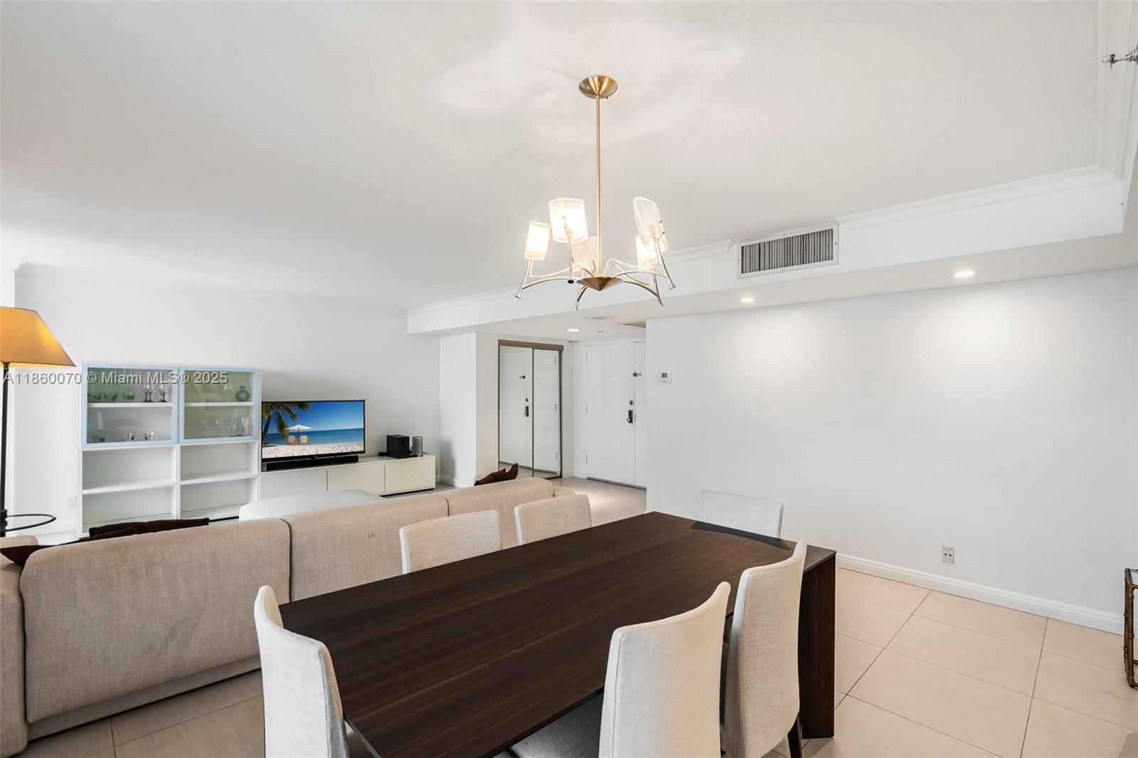 2401 Collins Avenue, Unit 1808 Miami Beach, FL 33140 - Photo 6 of 62 a living room with furniture and a chandelier