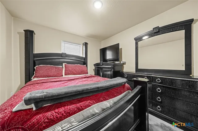 a bathroom with a sink a toilet a mirror and shower