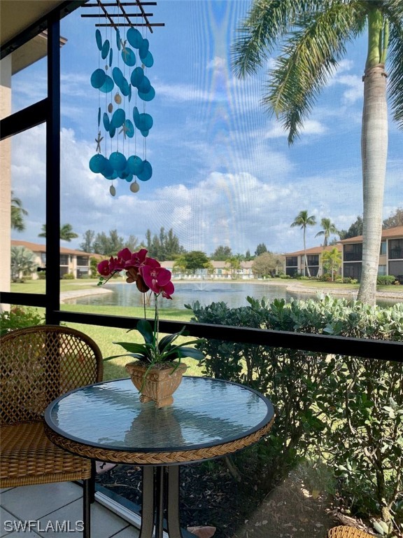 16881 Davis Road, Unit 216 Fort Myers, FL 33908 - Photo 4 of 26 a table with chairs and a vase of flower