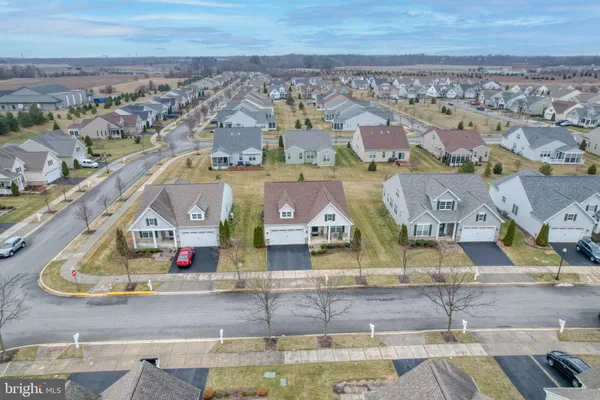 an aerial view of residential house with yard and mountain view