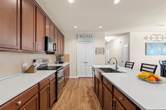 a kitchen with a sink appliances and cabinets