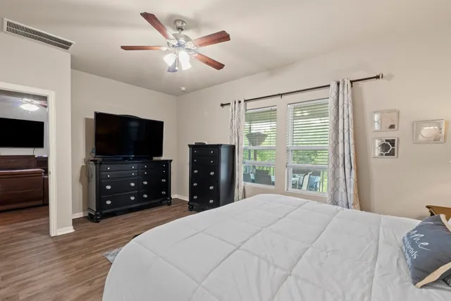 a bedroom with a bed and a flat screen tv
