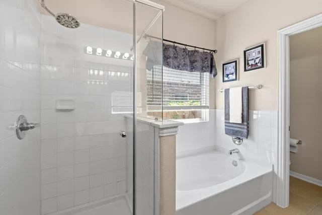 a bathroom with a bathtub and a shower