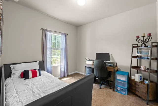 a bedroom with a workspace