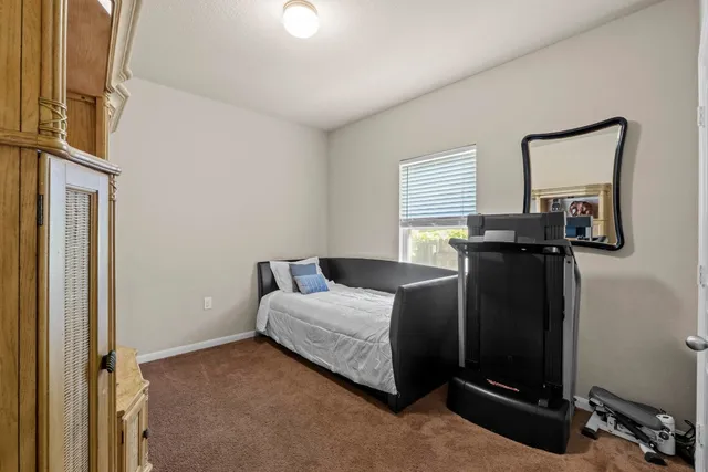 a bedroom with a bed and a mirror