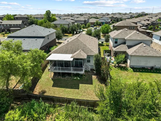 an aerial view of a house with a yard
