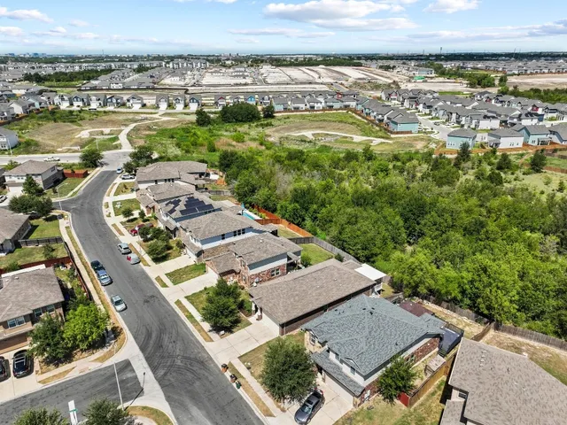 an aerial view of a residential building with swimming pool and ocean view