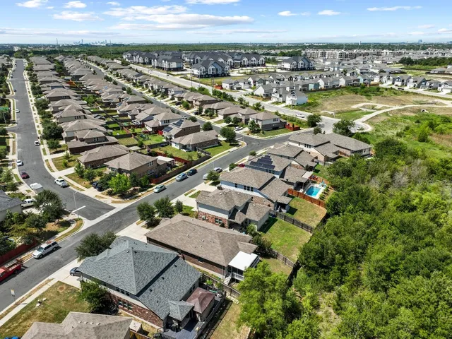 an aerial view of a residential building with swimming pool and ocean view