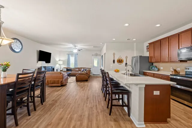 a large kitchen with a table and chairs