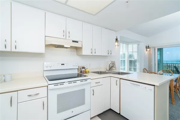 a view of a kitchen with sink and cabinets