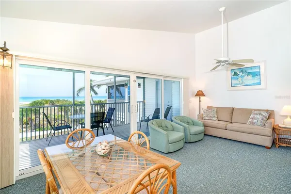 a living room with furniture and a floor to ceiling window