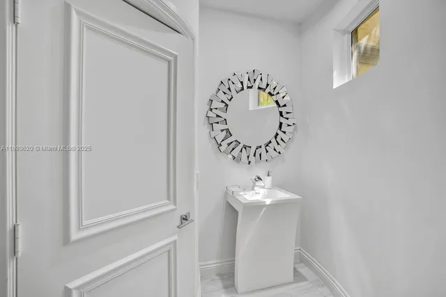 a bedroom with furniture and a large window