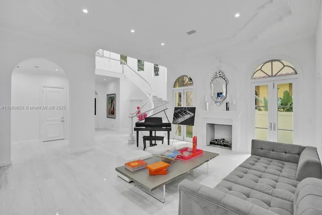 a kitchen that has a lot of white cabinets and stainless steel appliances
