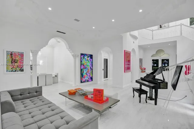 a living room with furniture and a chandelier