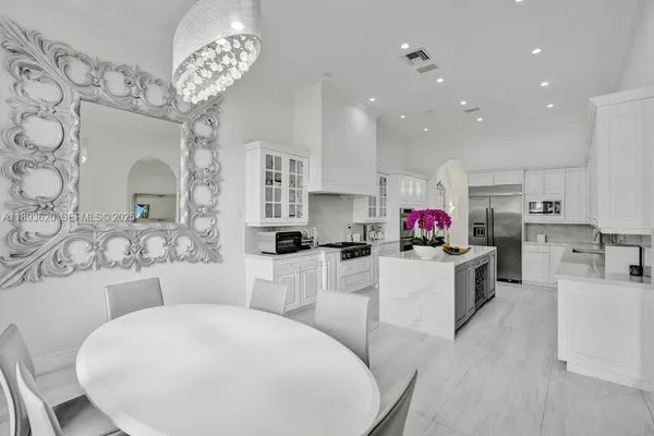 a view of a hallway view with wooden floor and a dining room