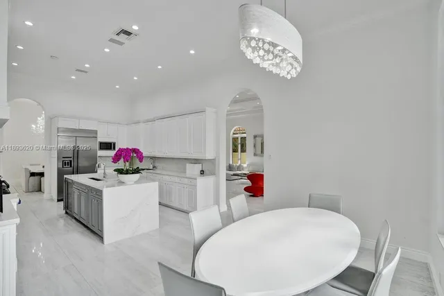 a view of a hallway with wooden floor and a living room