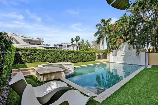a view of a swimming pool with a garden and trees