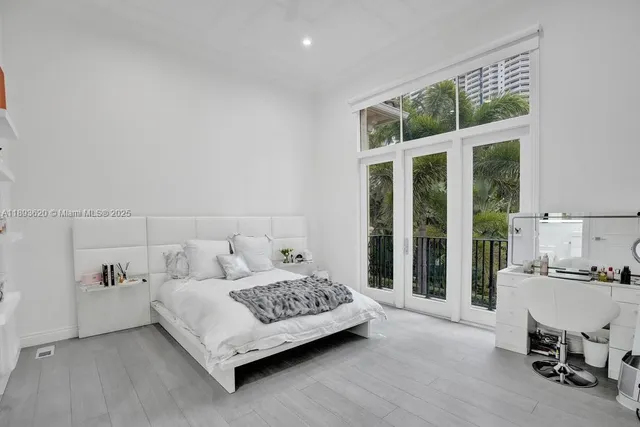 a large white bathroom with a double vanity sink a mirror and a bathtub