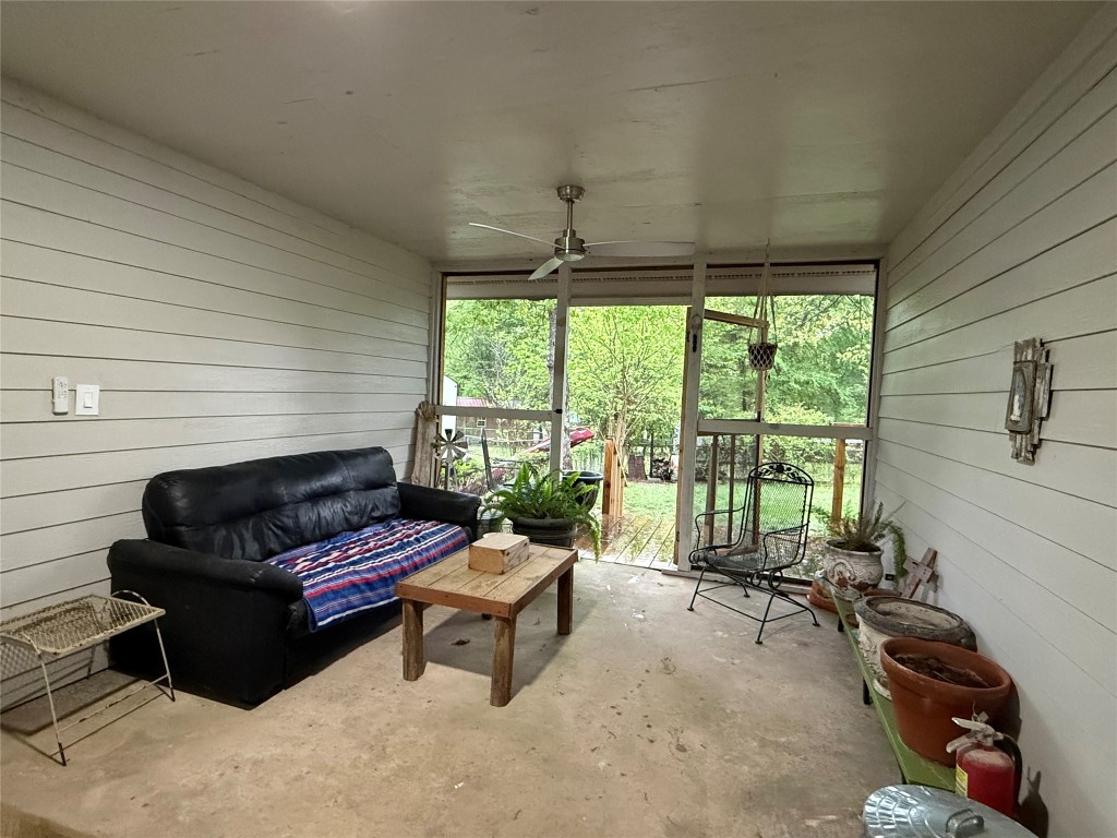 25 Ridge Top Drive Huntsville, TX 77320 - Photo 15 of 19 a living room with furniture and a floor to ceiling window