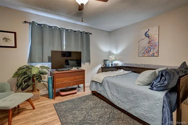 a bedroom with furniture and a flat screen tv