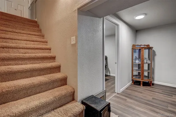 a view of entryway and hall with wooden floor