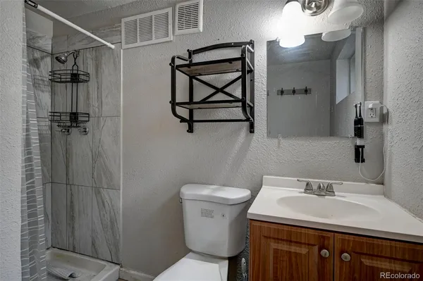 a bathroom with a sink toilet and shower