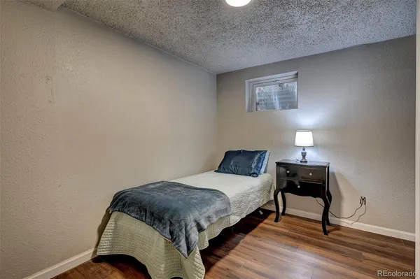 a bedroom with a bed and a lamp