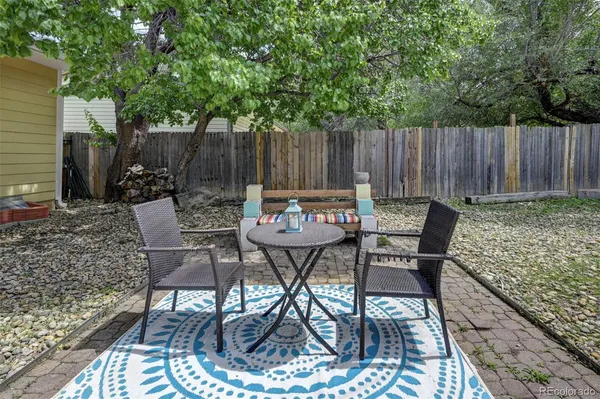 a view of a chairs and table in backyard
