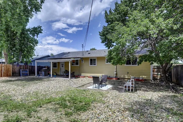 a view of a house with backyard porch and sitting area