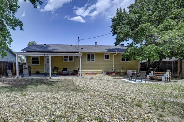 a front view of a house with patio furniture and fire pit