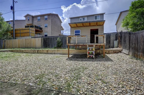 a view of two chairs in a backyard