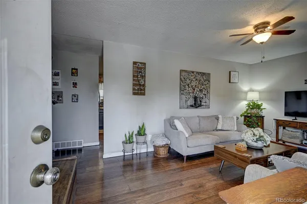 a living room with furniture wooden floor and a chandelier