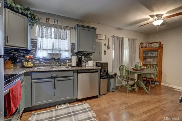 a kitchen with stainless steel appliances granite countertop a stove a sink refrigerator and cabinets