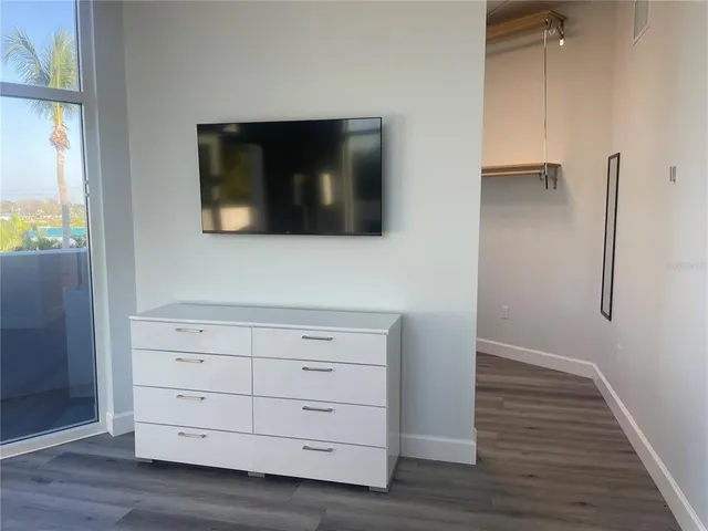 a view of empty room with wooden floor
