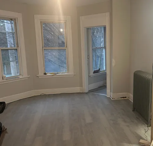 an empty room with windows and closet